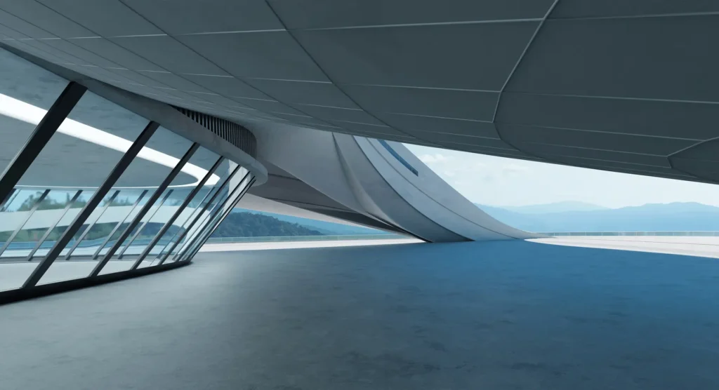 Futuristic commercial architecture by JMJ Estate India featuring sleek curved concrete and expansive glass windows.